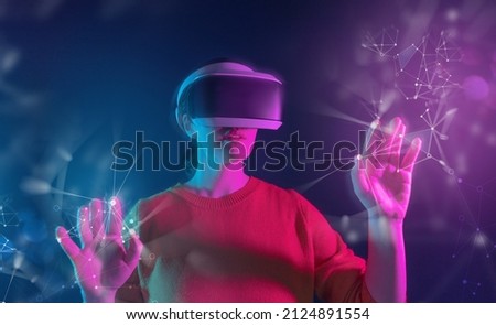 Metaverse technology concept. Woman with VR virtual reality goggles. Futuristic lifestyle. Royalty-Free Stock Photo #2124891554