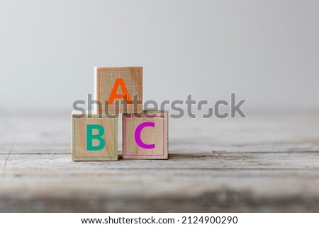 Illiteracy concept. ABC letters alphabet on wooden cube blocks on a wood table