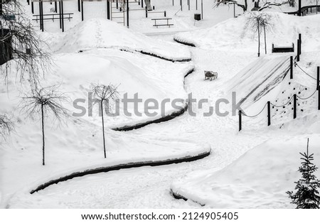 minimalistic picture of the snowy part of the park top view playground under the snow