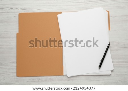 Yellow file with blank sheets of paper and pen on white wooden table, top view. Space for design Royalty-Free Stock Photo #2124954077