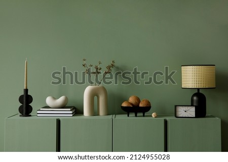 Modern living room interior composition with modern home decorations and personal accessories on the eucalyptus wooden commode. Eucalyptus wall. Template. Copy space. Royalty-Free Stock Photo #2124955028