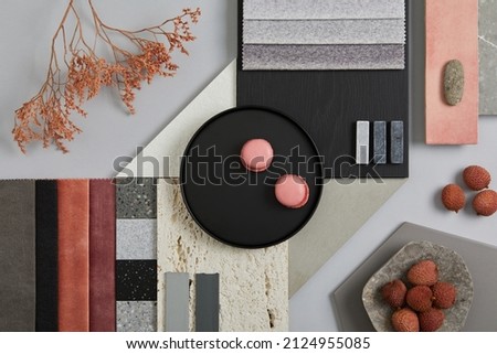Creative flat lay composition with textile and paint samples, panels and tiles. Stylish interior designer moodboard. Pink, black and light grey color palette. Copy space. Template. 