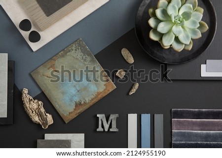 Creative flat lay composition with textile and paint samples, panels and tiles. Stylish interior designer moodboard. Black, blue, beige and dark grey color palette. Copy space. Template. 
