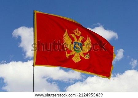 flag of Montenegro. Montenegro's national symbols. Montenegro's flag isolated on a sky background. A closeup of the Montenegrin flag waving.