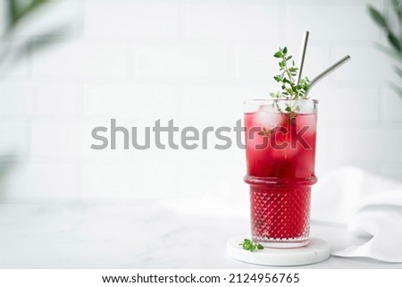 berry juice from blackcurrant and cranberries with ice in a glass, close-up Royalty-Free Stock Photo #2124956765