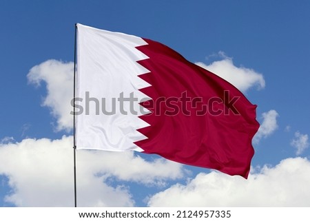 flag of Qatar. Qatar's national symbols. Qatari's flag isolated on a sky background.
