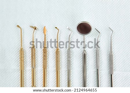 Dental Mirror, Hoe, Sickle, Scaler, Probe and ather tools from Stainless Steel. Professional dental set. Royalty-Free Stock Photo #2124964655