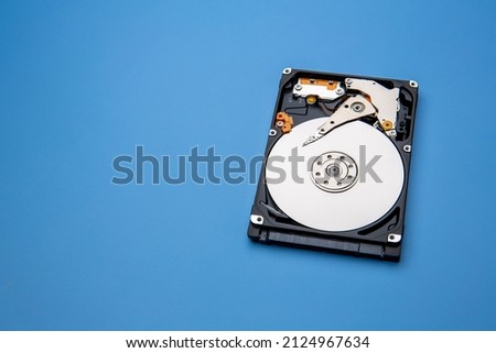 Hard disk drive and open cover. Computer hardware, hard disk, storage device. Detail of the inside of a hard disk drive. Hard disk is internal mechanism hardware Royalty-Free Stock Photo #2124967634