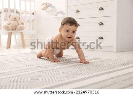 Cute baby crawling on floor at home Royalty-Free Stock Photo #2124970316