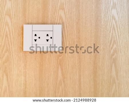 Electric outlet, Cable outlet and Electronic plug with Asia style on wood panel wall covering, cable television. Electricity concept for interior design.