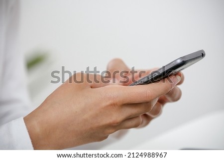 Hand holding a cell phone to log into social networks.