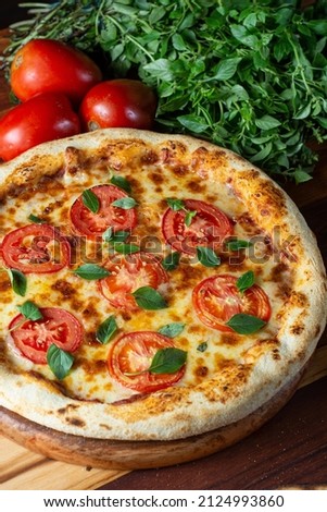 Pizza margherita, tomato, cheese and basil. Italian cuisine