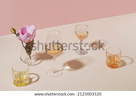 Assorted beverages or alcoholic drinks served in stylish glasses with flower on table with copy space Royalty-Free Stock Photo #2125003520
