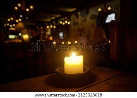 Candle on a table in a medieval tavern
