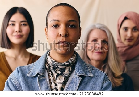 Mid adult LGBTQ woman in support of International Women's Day with multi-ethnic female friends Royalty-Free Stock Photo #2125038482
