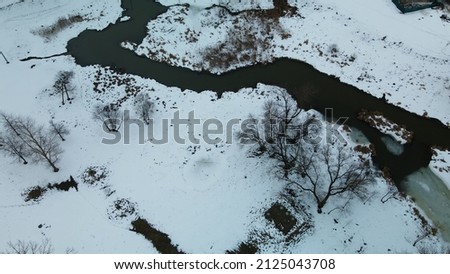 City park in winter. A meandering river is visible. Winter cityscape. Aerial photography.