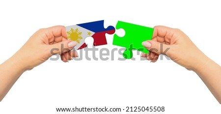 Woman hands are holding part of puzzle game. National mock up on white background. Philippines