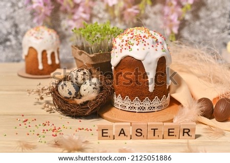 a postcard for the Easter holiday. easter cakes and eggs on a light brown table