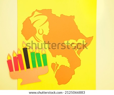 silhouette of the African continent with trees and the head of a woman in a turban and with earrings. Background for black history month or happy kwanzaa