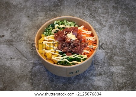 Set of fresh poke bowl with salmon, avocado, chukka, basil,shrimp and smoked fish on red background