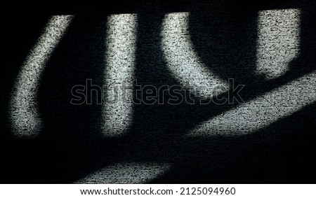 abstract design of shadows and light on window blind written symbols textured lines dark and light contrast black and white abstract textured background backdrop or wallpaper of symbols room for type