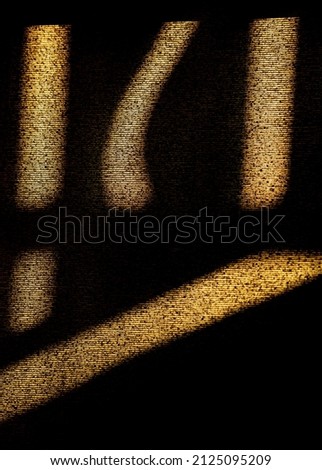 abstract design of shadows and yellow light shining through window on textured blind written symbols dark and light contrast vertical background backdrop or wallpaper room for type foreign writing
