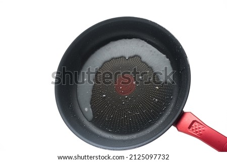 Dirty oily burnt metal frying pan or skillet. Close up studio shot, isolated on white background.