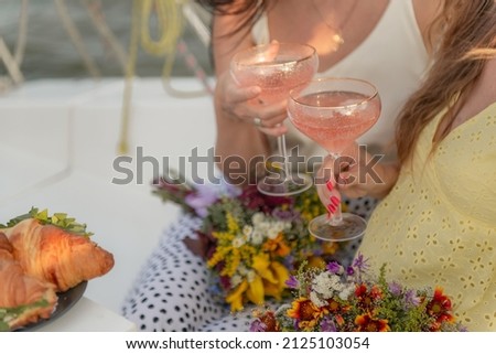 girlfriends with champagne and cupcakes in their hands
