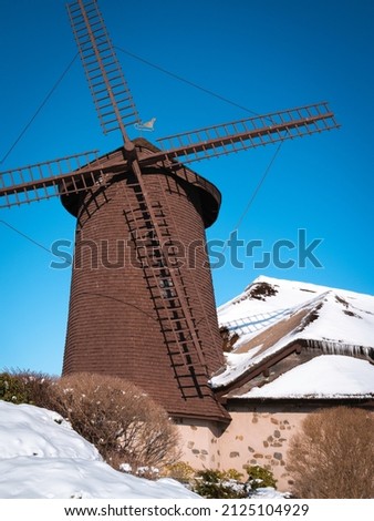 Windmill over the snow-covered roof