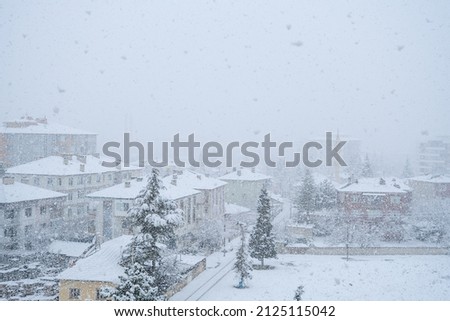 Neighborhood view with flaky snowfall, heavy snowy day.
Winter and town landscape. Royalty-Free Stock Photo #2125115042