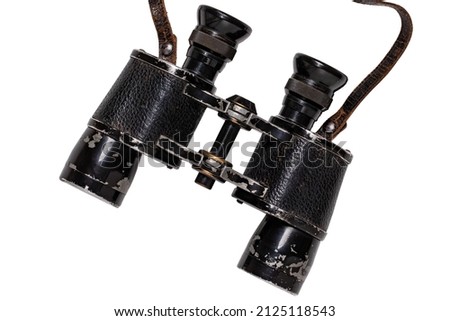 Vintage binoculars isolated. Close-up of an old german Binoculars with leather straps used from military during the second world war isolated on white. Macro. Clipping path.