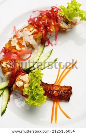 Dragon sushi rolls on white plate