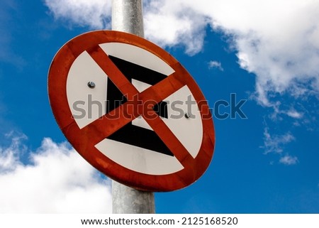 Brazilian traffic sign for prohibited to and park hanging from a pole