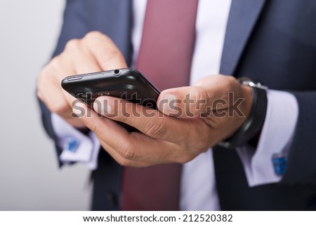 Businessman in suit holding a phone