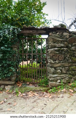 Wrought iron gate in slate wall in Robledillo de Gata