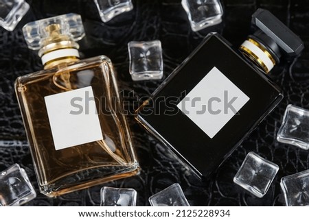 beautiful perfume bottle on black leather background