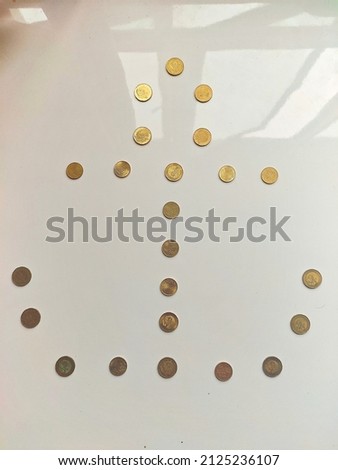 This is my coin art. Gold color are used in this art. It has white background. I also used sunlight to make my picture more brighter. 