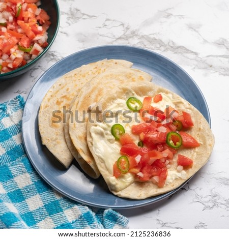 Quesadilla with fresh sauce called pico de gallo. Traditional mexican food