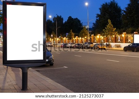 Blank vertical mockup with copy space for text message or promotional content next to the road at night. Mock-up.