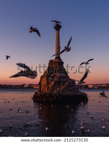 Sunset on the embankment of Sevastopol. Monument to sunken ships against the sun. Sevastopol, Crimea Royalty-Free Stock Photo #2125273130