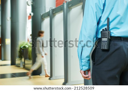 security guard controlling indoor entrance gate  Royalty-Free Stock Photo #212528509