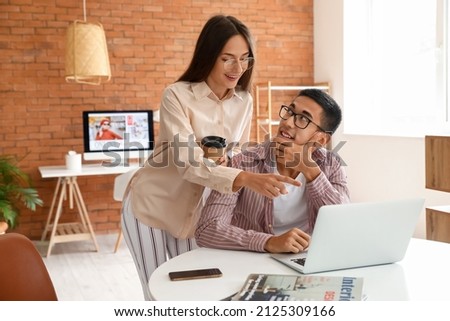 Young couple video chatting with laptop at home
