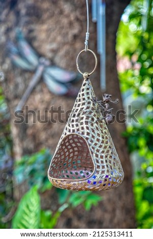garden decoration, metal ant and dragonfly hanging on a tree 