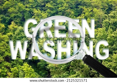 Alert to Greenwashing - concept with text against a forest and trees and magnifying glass Royalty-Free Stock Photo #2125321571