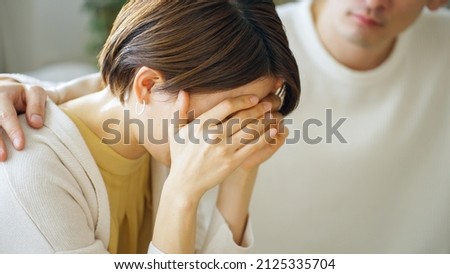 Asian couple depressed at home Royalty-Free Stock Photo #2125335704