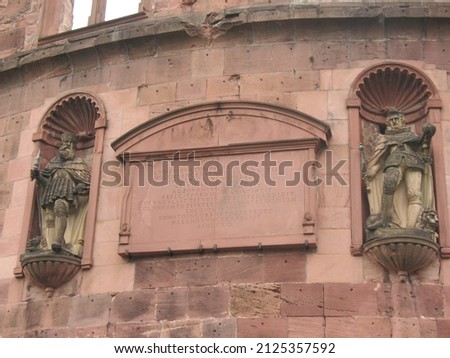Large ancient castle in a German city. The castle is decorated with various figures. Vintage for postcards.
