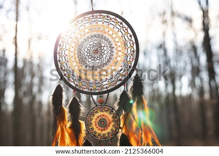 Dream catcher with feathers threads and beads rope hanging. Dreamcatcher handmade Royalty-Free Stock Photo #2125366004