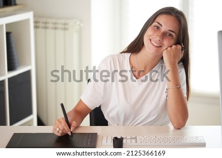 Portrait of beautiful caucasian photographer woman watching prints on frames and working ah home studio. Business people employee freelance online marketing.