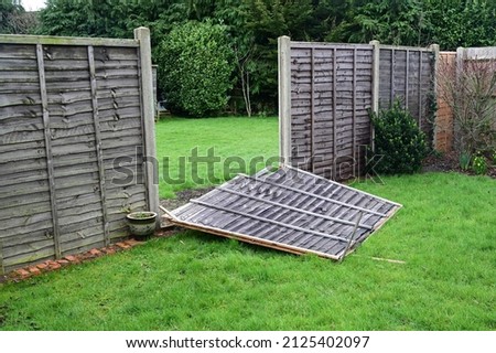 Storm "Eunice" damage to a garden fence in the UK on 18 Feb 2022.  Royalty-Free Stock Photo #2125402097