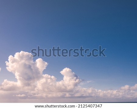 Fluffy white clouds and blue sky